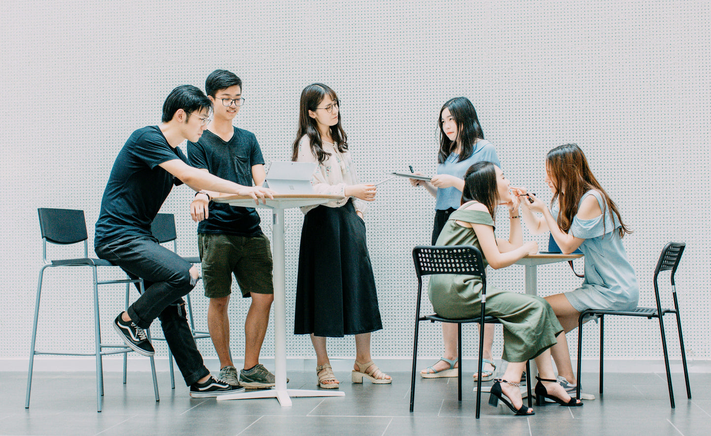Team of young professionals collaborating around a table in an indoor setting