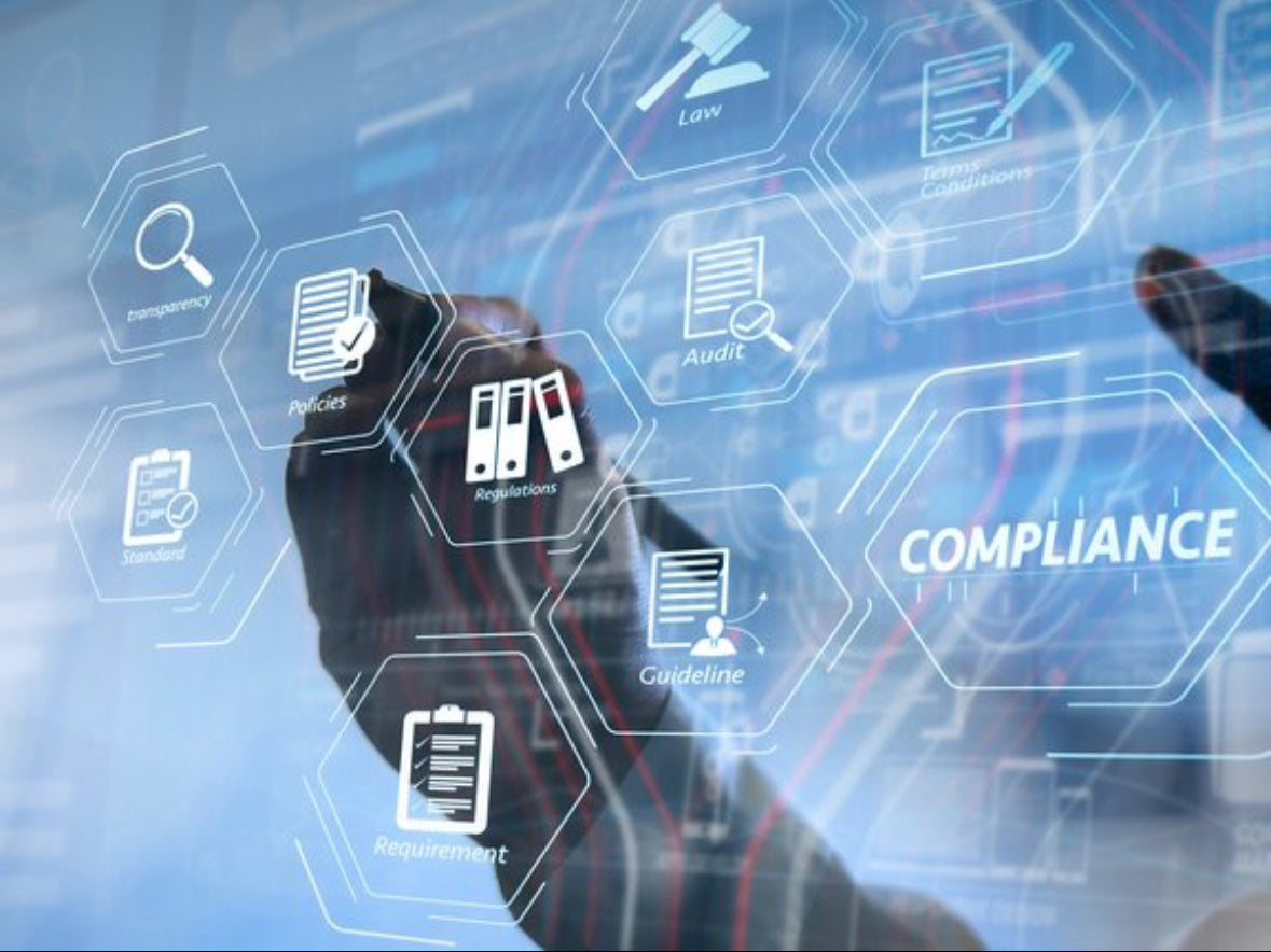 Person interacting with a digital interface displaying compliance icons on a blue background